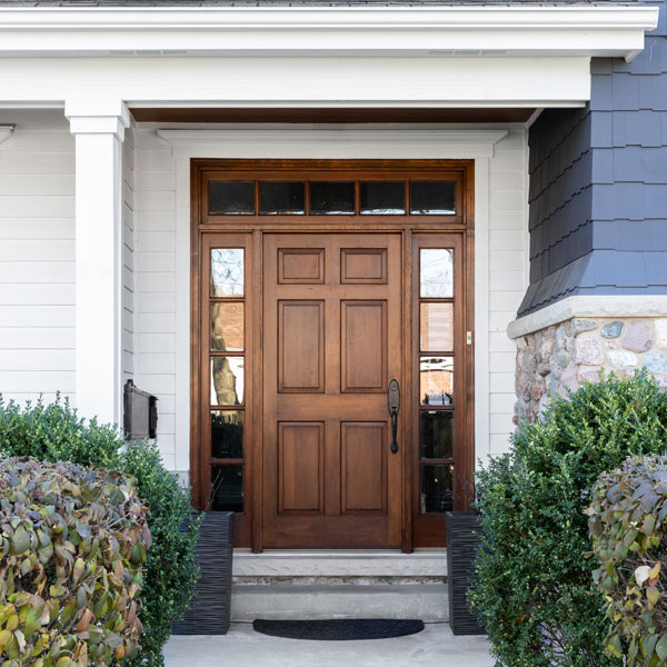 large wooden door on front of residential home