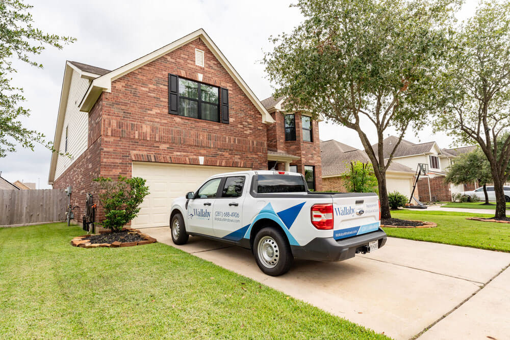 Wallaby truck in driveway of home with new windows